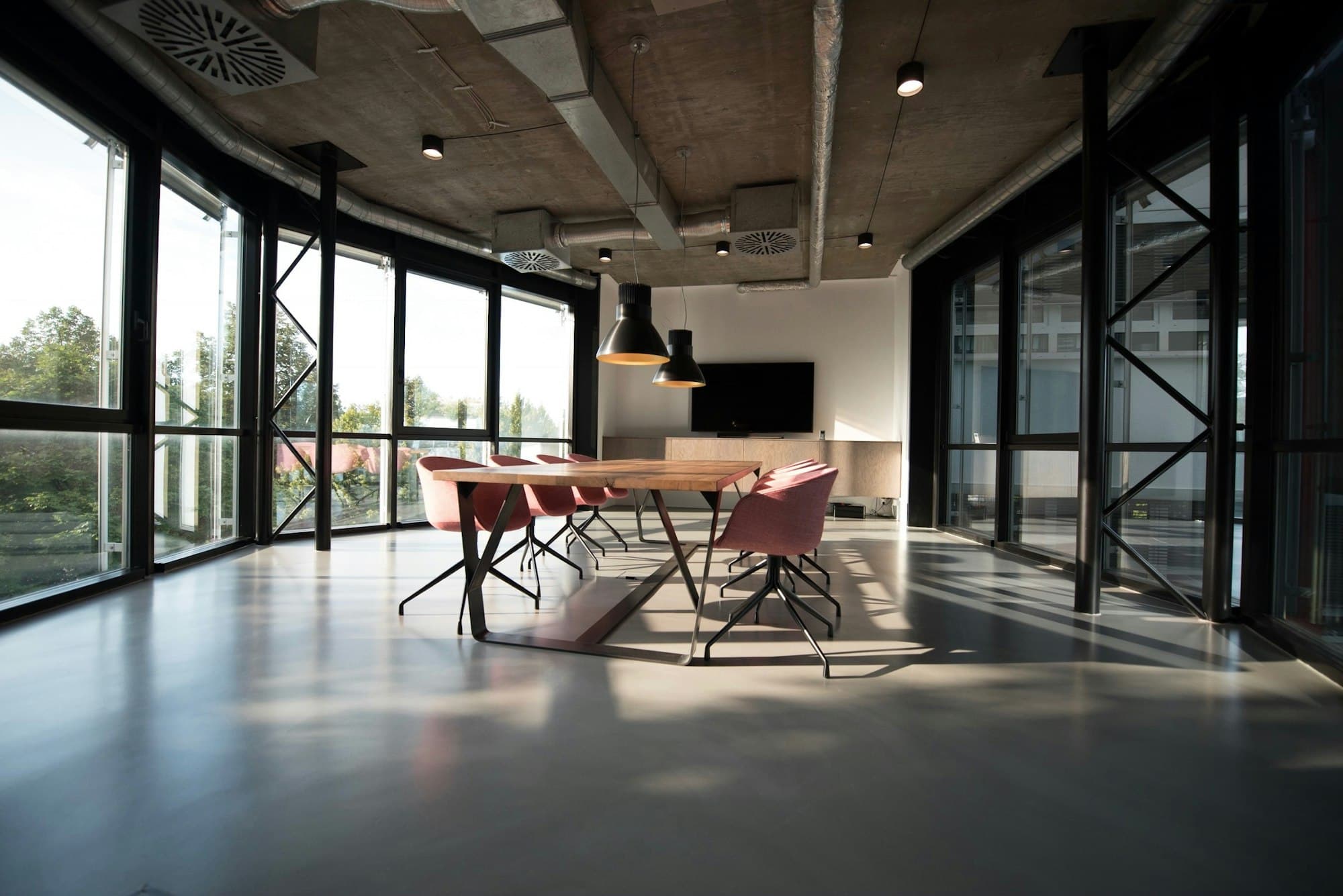 Open commercial office with desks, chairs, and large windows